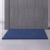 Blue rectangular shower tray with a central drain against a gray tiled wall in a glass-enclosed shower area.